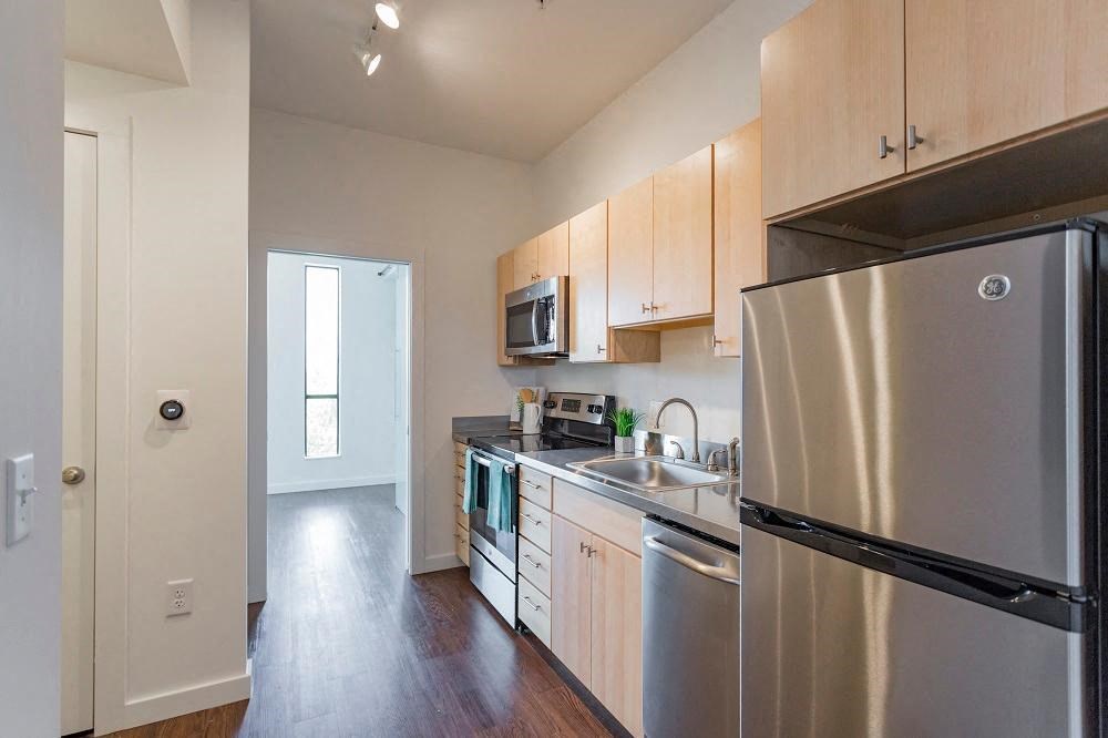 a kitchen with stainless steel appliances and white cabinets