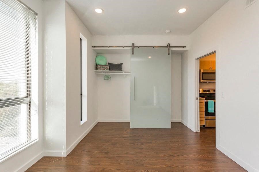 an empty living room with a sliding glass door