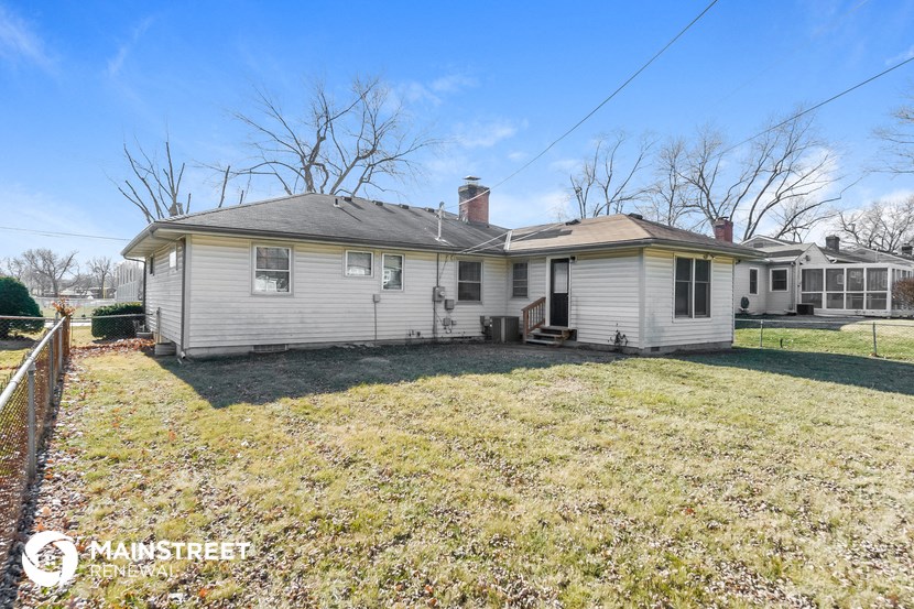 a white house with a yard and a fence