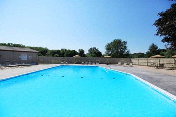 a large blue swimming pool on a sunny day