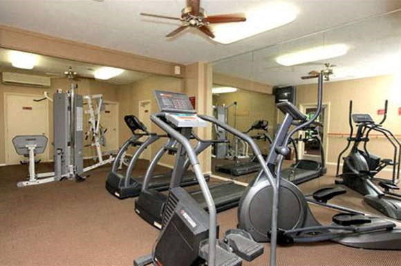 a gym with several pieces of exercise equipment