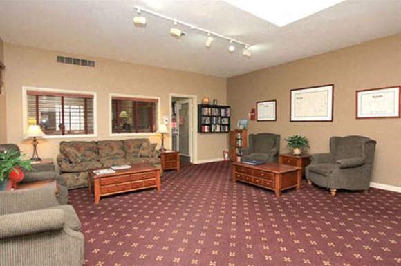 a living room with couches chairs and a table