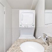a bathroom with a sink and a toilet and a washing machine