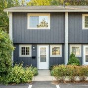 the front of a blue house with a white door