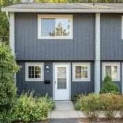 the front of a blue house with a white door
