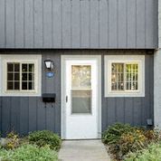 a blue house with a white door and windows