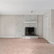 a living room with a fireplace and a carpet