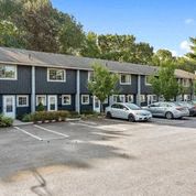 a parking lot with cars in front of a building