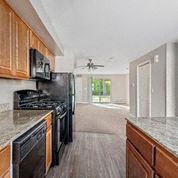 a large kitchen with a stove and a refrigerator
