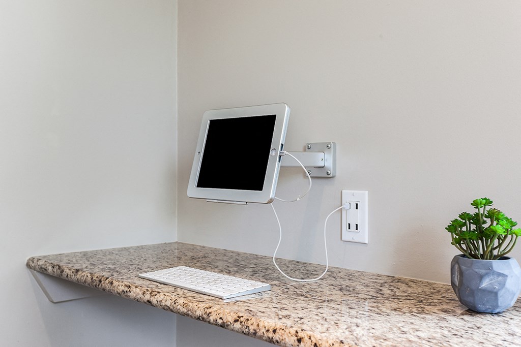 a desk with an and a keyboard on it on a wall