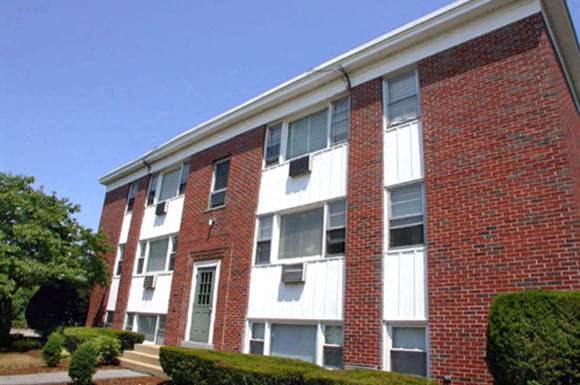 a red brick apartment building with steps