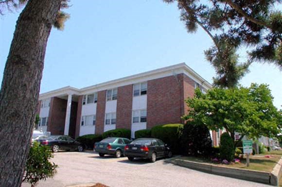 a large brick building with cars parked in front of it