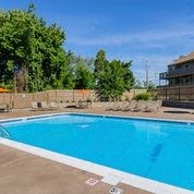 a swimming pool with blue water in a yard