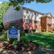 a house with a yard and a sign in front of it