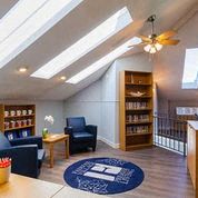 a living room with furniture and a ceiling fan