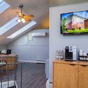 a living room with a ceiling fan and a coffee table
