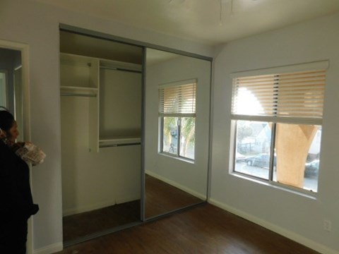 an empty room with a window and a mirror