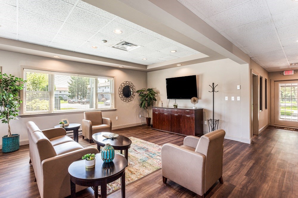 a living room with couches and chairs and a television