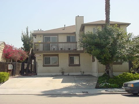A house with a car parked in front.