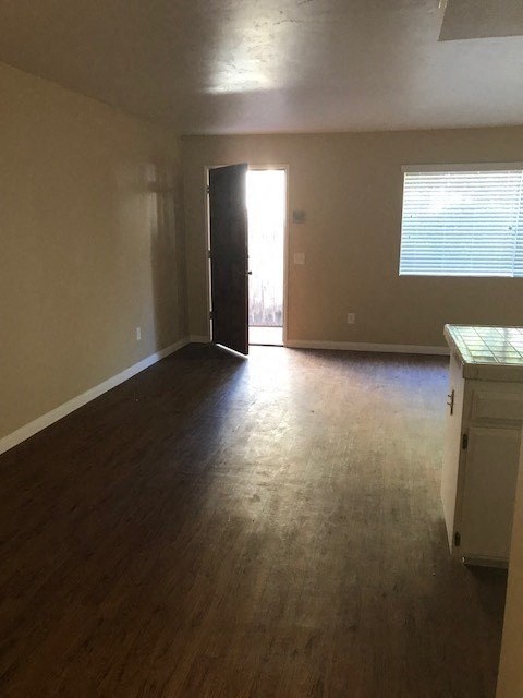 A room with a wooden floor and a white cabinet.