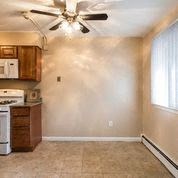 a kitchen with a stove top oven next to a window