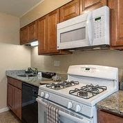 a kitchen with a stove a sink and a microwave