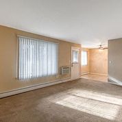 an empty living room with a large window