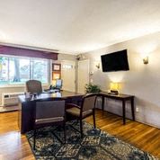 a living room with a desk and a tv