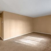 an empty room with tan walls and a white ceiling