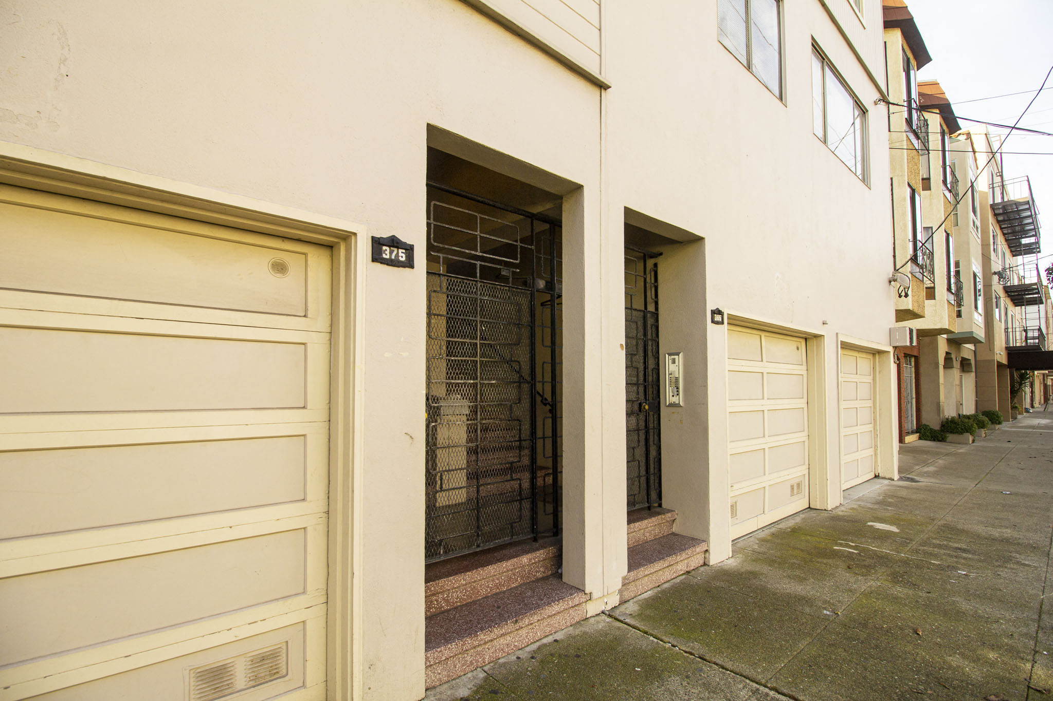 A white building with a number 375 on the door.