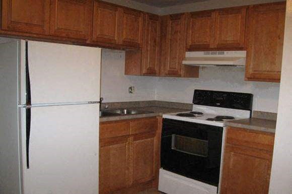 a kitchen with a stove and a refrigerator