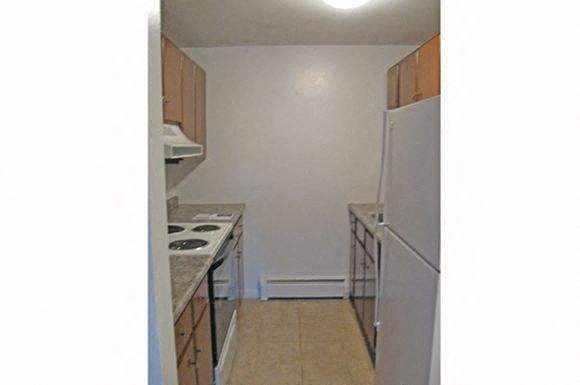 a small kitchen with a stove and a refrigerator