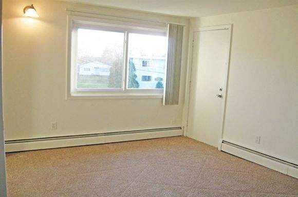 an empty room with a window and a door