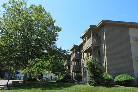 an apartment building with trees in front of it