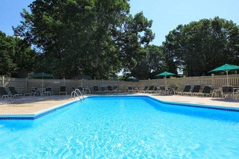 a large swimming pool with chairs around it