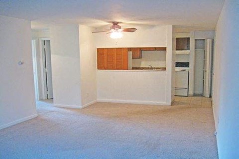 an empty empty living room with a ceiling fan