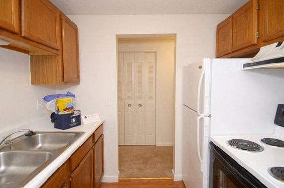 a small kitchen with a stove and a refrigerator