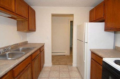 a kitchen with a sink and a refrigerator