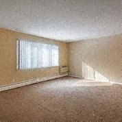 an empty living room with a large window