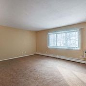 an empty living room with a large window