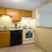 a kitchen with a stove top oven and a sink