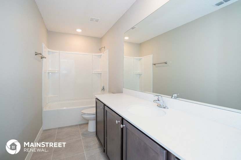 a bathroom with a sink and a toilet and a shower