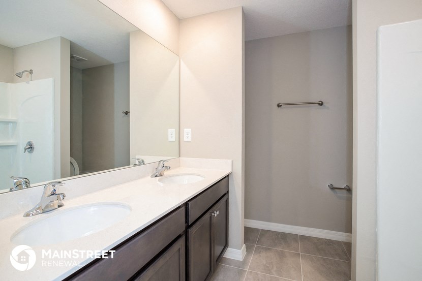 a bathroom with two sinks and a large mirror
