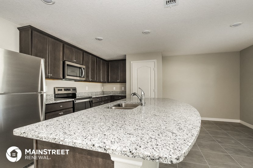 a kitchen with granite counter top and stainless steel appliances