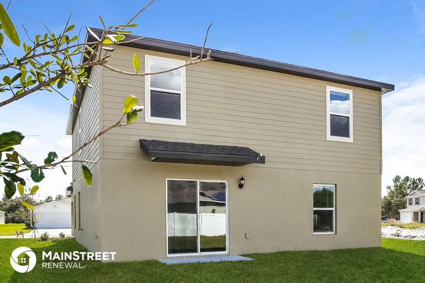 a small house with a tree in front of it