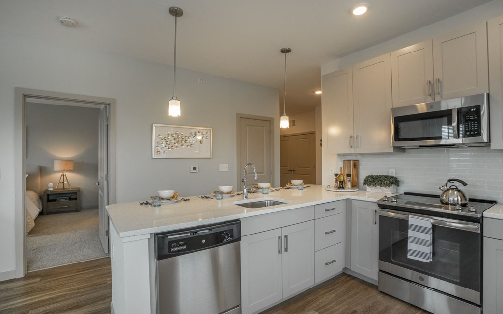 a kitchen with white cabinets and stainless steel appliances