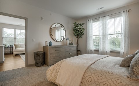 a bedroom with a large bed and a mirror
