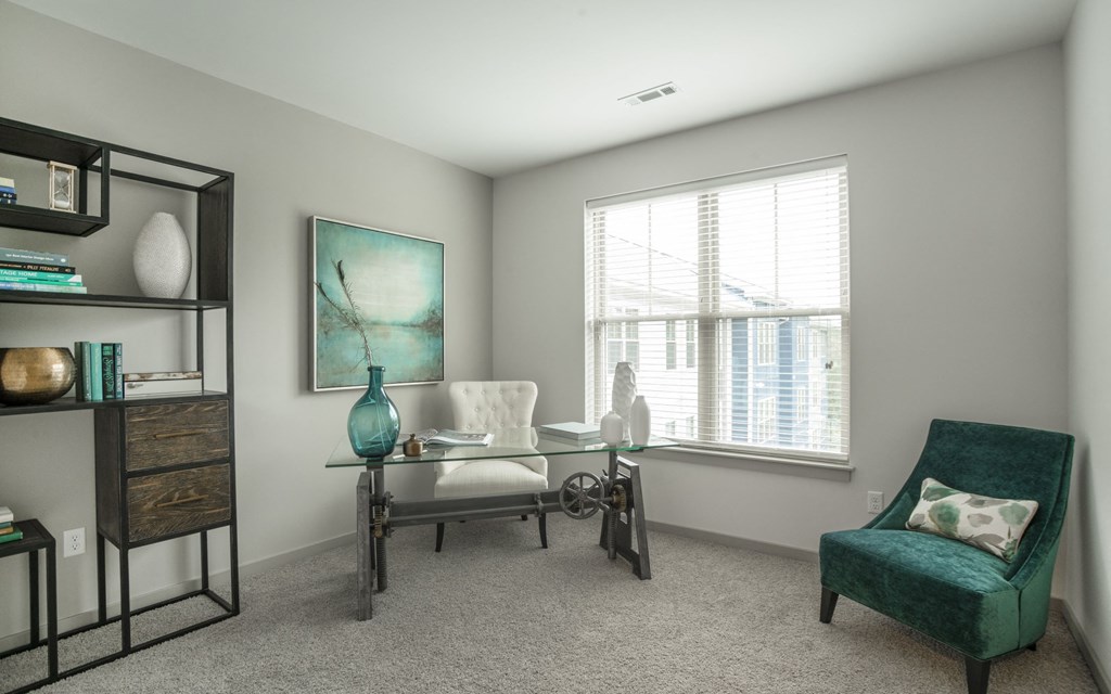 an office with a large window and a desk with a chair