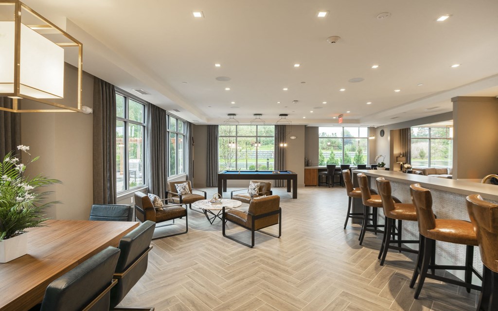 a clubhouse with a bar and tables and chairs