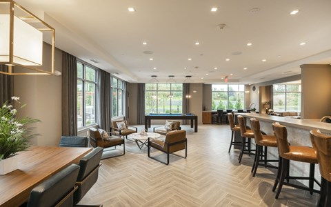 a clubhouse with a bar and tables and chairs